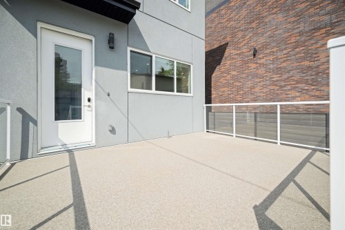 Expansive outdoor patio with durable aggregate surface - 14037 104 Avenue, Edmonton, AB - Outdoor With Exterior