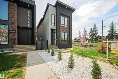 Contemporary exterior featuring dark brick accents, light grey siding, and large windows - 14037 104 Avenue, Edmonton, AB - Outdoor
