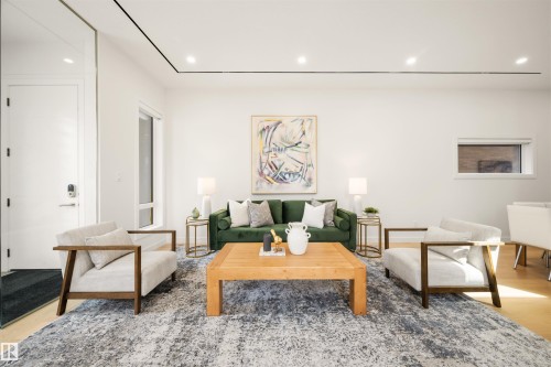 Open-concept living space featuring high ceilings, recessed lighting, wood-finish flooring, and a large window - 14037 104 Avenue, Edmonton, AB - Indoor Photo Showing Living Room