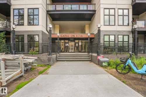 Building facade featuring a prominent entrance with "GATES ON 117th" signage, dark brick accents, and multiple windows - 126 10531 117 Street, Edmonton, AB 