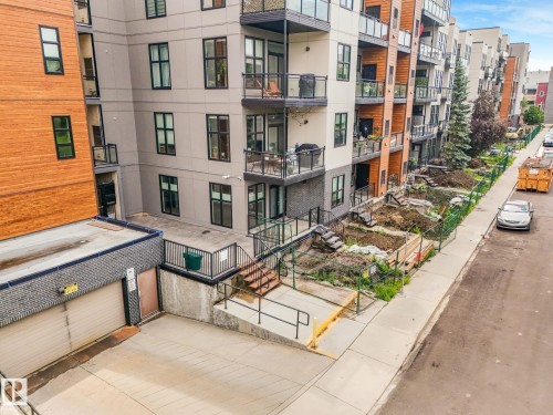 Modern multi-story building featuring multiple balconies with glass railings - 126 10531 117 Street, Edmonton, AB 