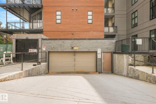 Concrete ramp providing access to a ground-level garage door and an additional pedestrian entrance - 126 10531 117 Street, Edmonton, AB 
