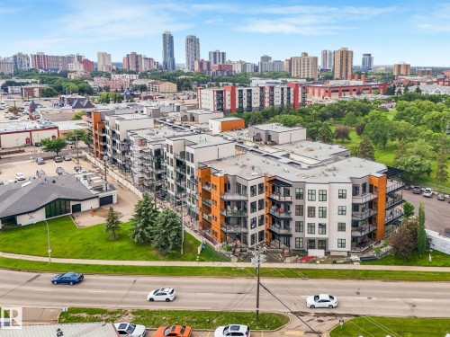 Contemporary multi-story building featuring a distinctive facade with white, grey, and wood-toned panels - 126 10531 117 Street, Edmonton, AB 