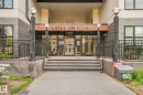 Main entrance featuring concrete steps, wrought iron fencing, decorative address signage, and exterior lighting fixtures - 126 10531 117 Street, Edmonton, AB 