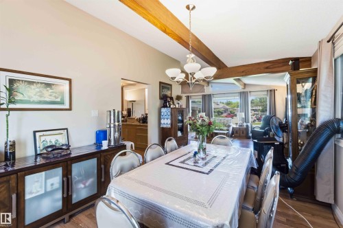 Vaulted ceilings featuring exposed wood beams enhance this dining area - 13121 122 Street, Edmonton, AB 