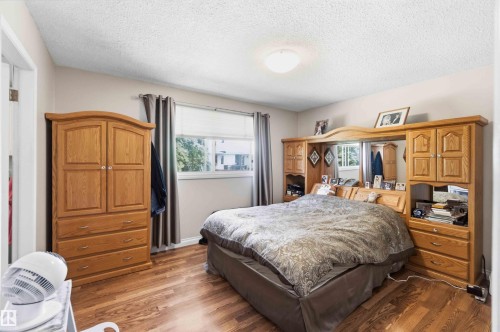 Interior room with wood-finish flooring, a neutral wall color, and white ceiling - 13121 122 Street, Edmonton, AB 