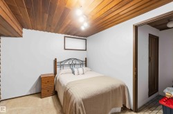 Wood-paneled ceiling with recessed lighting - 