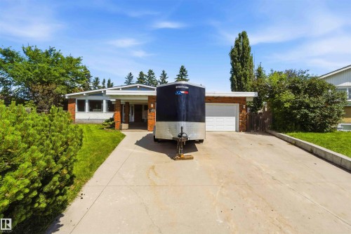 Mid-century modern residence featuring a brick facade and an attached garage - 13121 122 Street, Edmonton, AB 