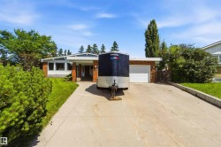Mid-century modern residence featuring a brick facade and an attached garage - 
