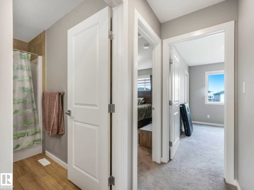 Hallway with light gray wall paint, white trim, and white doors - 516 35 Street, Edmonton, AB 