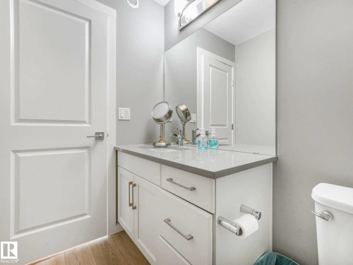 White vanity with a light-toned countertop, under-mount sink, and chrome hardware - 516 35 Street, Edmonton, AB 