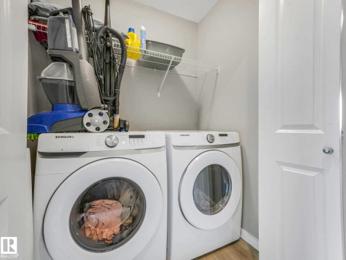 Dedicated laundry area featuring a front-loading washer and dryer set - 516 35 Street, Edmonton, AB 