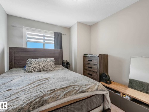 Bedroom featuring light gray walls and carpeted flooring - 516 35 Street, Edmonton, AB 