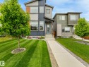 Contemporary facade featuring a multi-tone exterior, large windows, stone accents, and a covered entryway - 516 35 Street, Edmonton, AB 