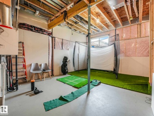 Unfinished basement with exposed ceiling joists, concrete flooring, and insulated wall sections - 516 35 Street, Edmonton, AB 