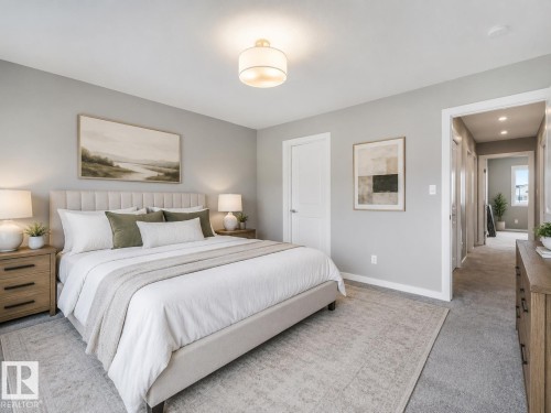 Carpeted room with light gray walls and a fabric upholstered bed frame - 516 35 Street, Edmonton, AB 