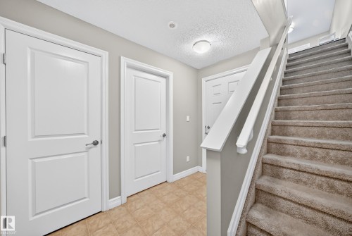 Carpeted staircase with white balusters, leading to an upper level - 10-415 Clareview Rd Nw Nw, Edmonton, AB 