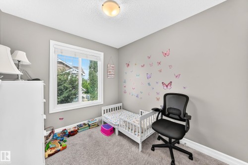 Bedroom with a large window, neutral wall paint, and gray carpet flooring - 10-415 Clareview Rd Nw Nw, Edmonton, AB 