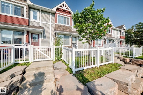 Multi-level townhouse exterior featuring durable siding, stone accents, and gabled rooflines - 10-415 Clareview Rd Nw Nw, Edmonton, AB 