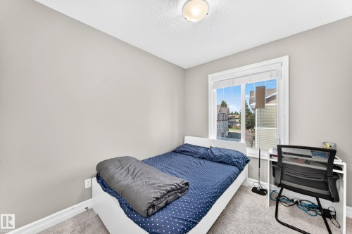 Light gray painted walls define this bright bedroom featuring a large window with white blinds - 10-415 Clareview Rd Nw Nw, Edmonton, AB 