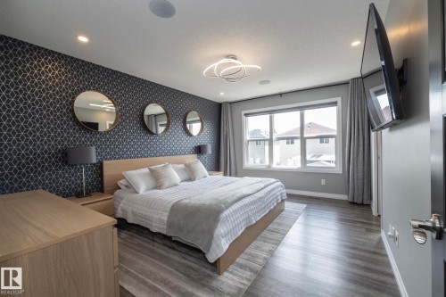 Accent wall featuring geometric patterned wallpaper - 923 Mcconachie Boulevard, Edmonton, AB 