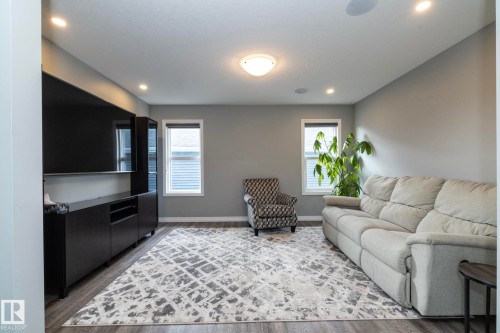 Spacious room featuring wood-finish flooring, light gray walls, and recessed lighting - 923 Mcconachie Boulevard, Edmonton, AB 