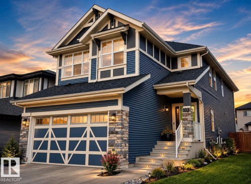 Two-story residence featuring blue horizontal siding and light stone accents - 923 Mcconachie Boulevard, Edmonton, AB 