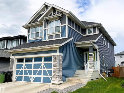 Contemporary two-story residence featuring blue siding and stone accents - 923 Mcconachie Boulevard, Edmonton, AB 