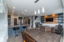 Open-concept living space featuring wood-finish flooring - 923 Mcconachie Boulevard, Edmonton, AB 