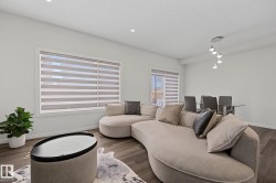 Open-concept living area with dark wood-finish flooring - 