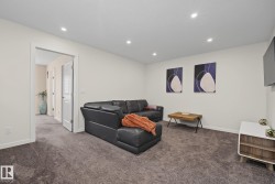 Spacious room featuring plush gray carpeting, recessed ceiling lighting, and crisp white walls - 