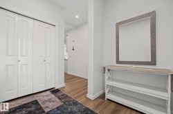 Well-lit entry area featuring light wood-finish flooring - 