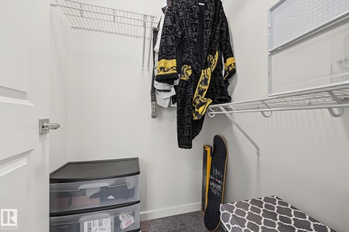 White-painted closet featuring durable wire shelving and a hanging rod for clothing organization - 432 Roberts Crescent, Leduc, AB 