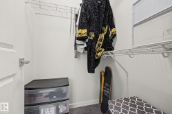 White-painted closet featuring durable wire shelving and a hanging rod for clothing organization - 