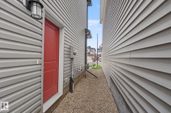 Red entry door with an overhead lantern fixture - 