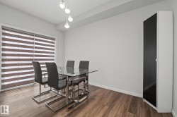 Wood-finish flooring throughout, complemented by a contemporary light fixture - 