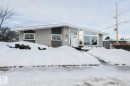Single-story residence featuring light gray siding with dark stone accents - 13304 70 Street, Edmonton, AB 