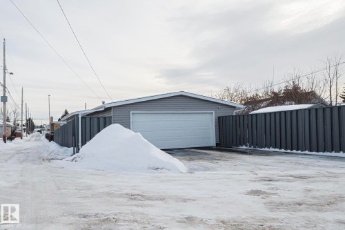 Detached garage featuring light gray siding and a white overhead door - 13304 70 Street, Edmonton, AB 