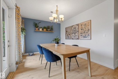 Light wood-finish flooring complements the interior space - 2696 Anderson Crescent, Edmonton, AB - Indoor Photo Showing Dining Room