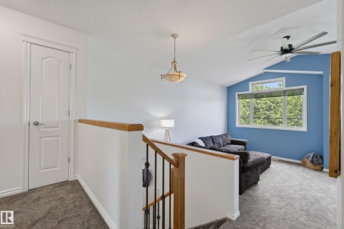 Loft area with vaulted ceiling, large windows, and a modern ceiling fan - 2696 Anderson Crescent, Edmonton, AB - Indoor Photo Showing Other Room