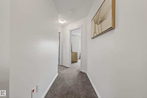 Hallway with light gray carpeting and white painted walls - 2696 Anderson Crescent, Edmonton, AB - Indoor Photo Showing Other Room