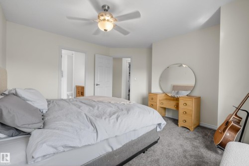 Carpeted bedroom featuring neutral paint tones and a ceiling fan with integrated lighting - 2696 Anderson Crescent, Edmonton, AB - Indoor Photo Showing Bedroom