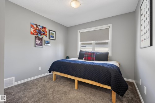 Neutral gray wall color complemented by white baseboards and window trim - 2696 Anderson Crescent, Edmonton, AB - Indoor Photo Showing Bedroom