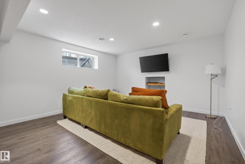 Recessed lighting illuminates this space featuring wood-finish flooring - 2696 Anderson Crescent, Edmonton, AB - Indoor