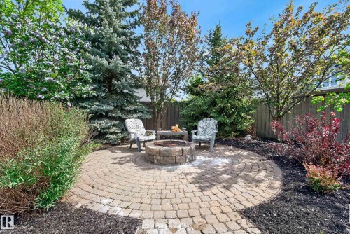 Circular paver patio featuring a built-in stone fire pit - 2696 Anderson Crescent, Edmonton, AB - Outdoor