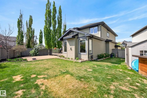 Rear exterior featuring light-colored siding, a multi-level roofline, and a bay window - 2696 Anderson Crescent, Edmonton, AB - Outdoor