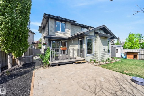 Rear exterior featuring light green siding and dark trim accents - 2696 Anderson Crescent, Edmonton, AB - Outdoor With Deck Patio Veranda