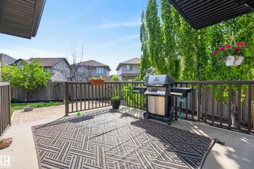 Outdoor deck area featuring a concrete surface and dark wood railing - 2696 Anderson Crescent, Edmonton, AB - Outdoor With Deck Patio Veranda With Exterior