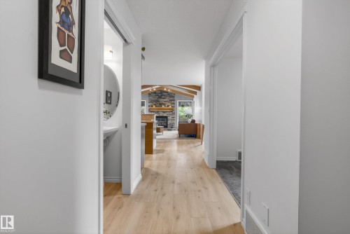 Hallway featuring light wood-finish flooring, white baseboards, and a neutral wall palette - 2696 Anderson Crescent, Edmonton, AB - Indoor Photo Showing Other Room