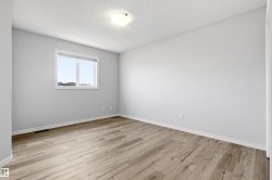 Light wood-finish flooring complements the neutral wall tones - 